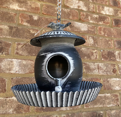 Bird Perched on top of Birdhouse